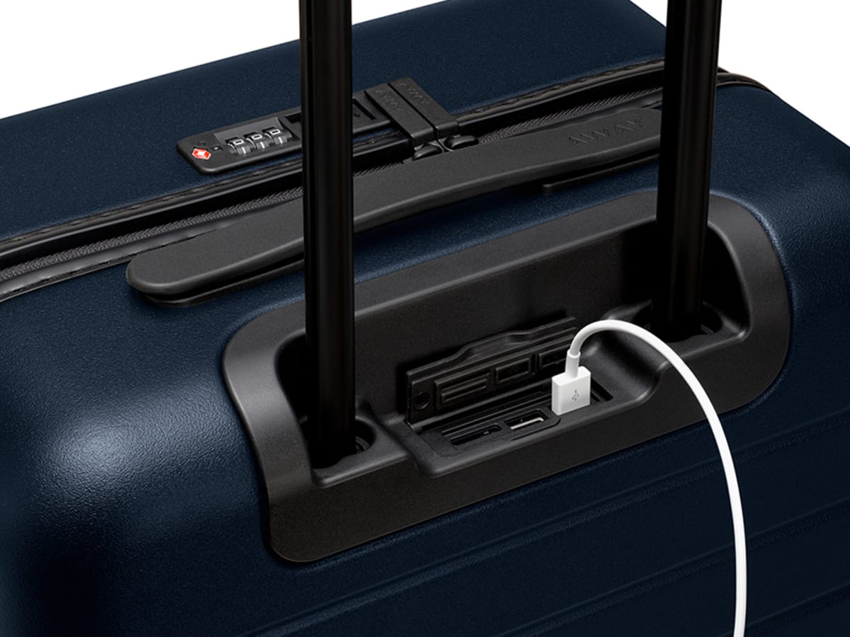 Suitcase with ejectable battery top