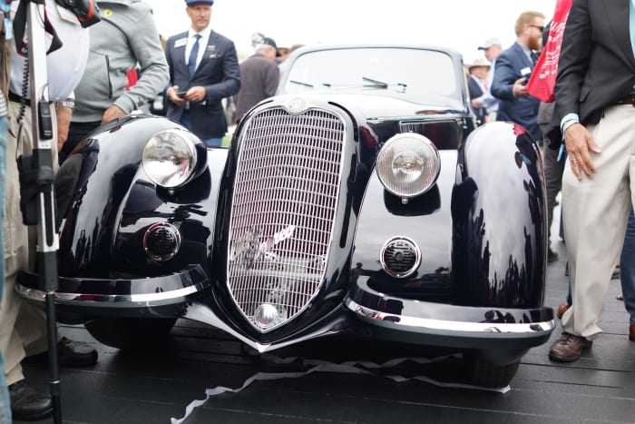 Onlookers getting a look at this year's Concours 'Best of Show', the 1937 Alfa Romeo 8C 2900B Touring Berlinetta.
